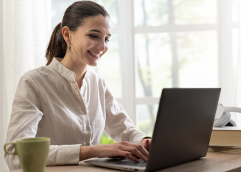 Woman working at laptop smiling