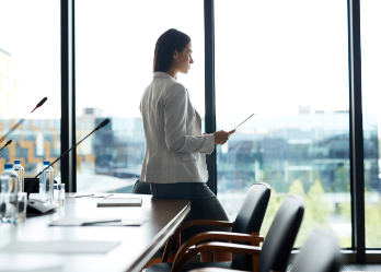 Side view portrait of businesswoman at conference table