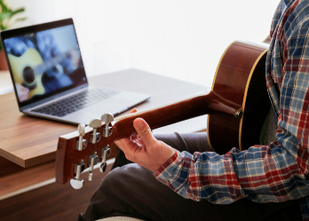 Man taking an online musical courses at home during quarantine
