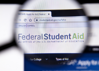 Federal Student Aid website in magnifying glass