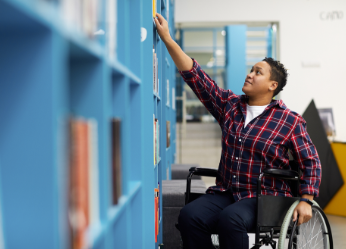 Man in wheelchair in library