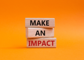 Wooden blocks reading 'make an impact'