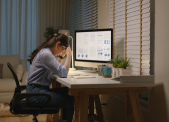 Asian woman researching on computer, looking frustrated