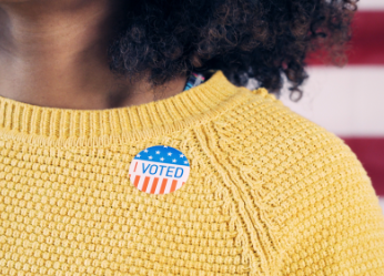 Young African American woman with I Voted sticker